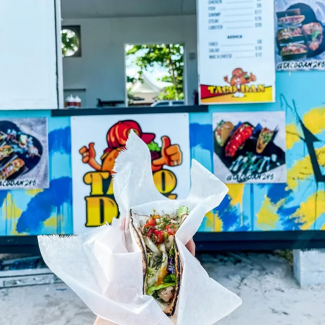 A taco in front of the Taco Dan food truck